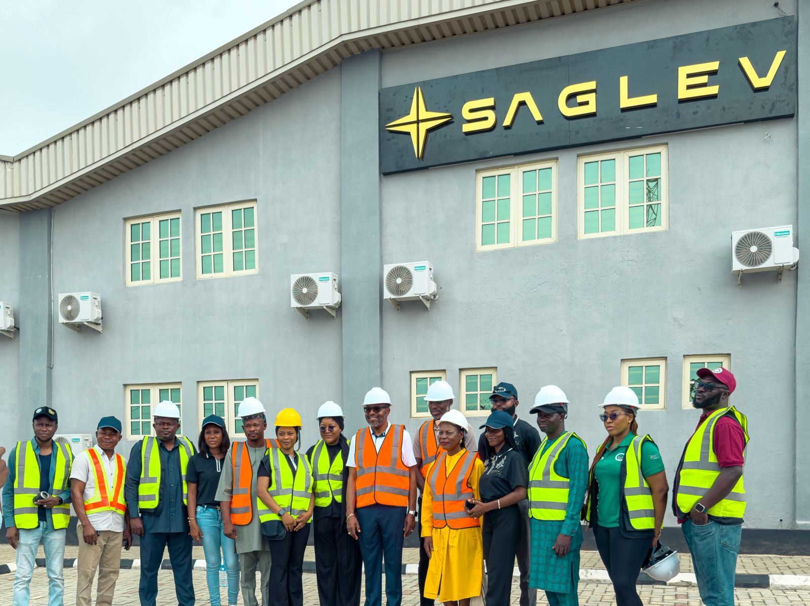 Workers on the floor of an electric vehicle manufacturing facility equipped with modern assembly lines.